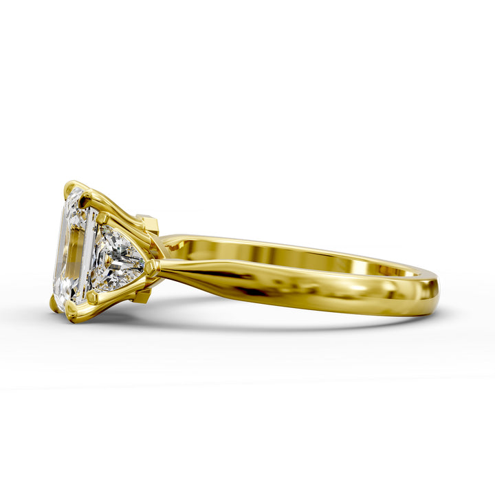 emerald-cut three-stone engagement ring with trapezoid side diamonds and tapered band shown from multiple angles