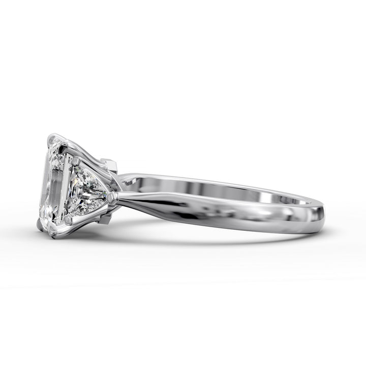 emerald-cut three-stone engagement ring with trapezoid side diamonds and tapered band shown from multiple angles