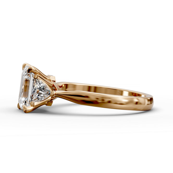 emerald-cut three-stone engagement ring with trapezoid side diamonds and tapered band shown from multiple angles