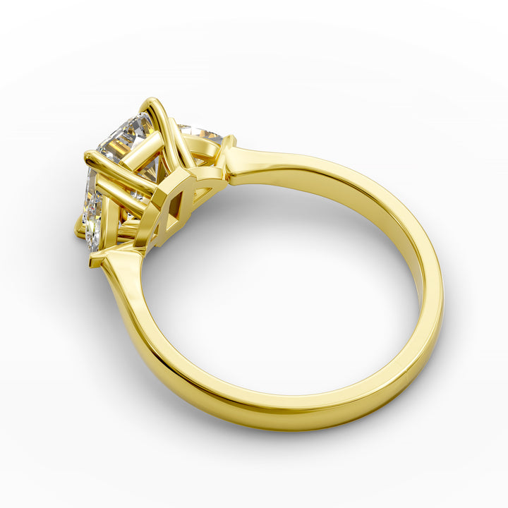 emerald-cut three-stone engagement ring with trapezoid side diamonds and tapered band shown from multiple angles