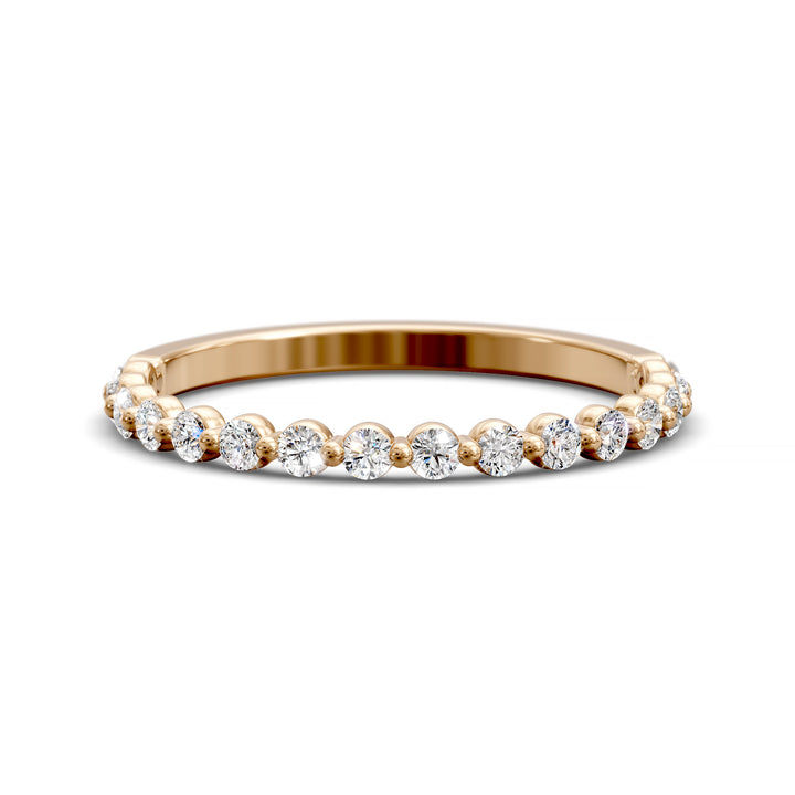 Floating diamond shared prong wedding band with round stones in gold