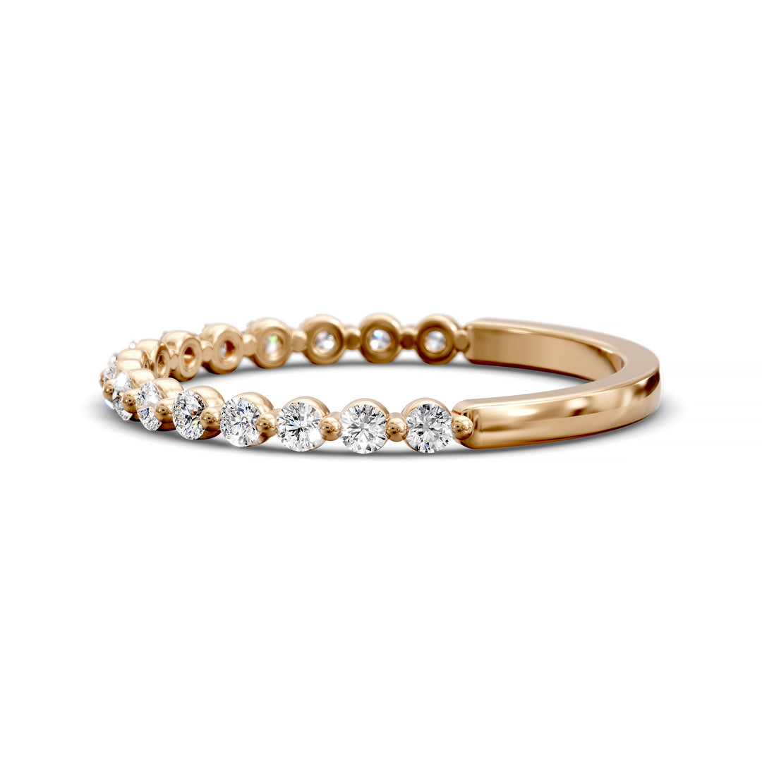 Floating diamond shared prong wedding band with round stones in gold