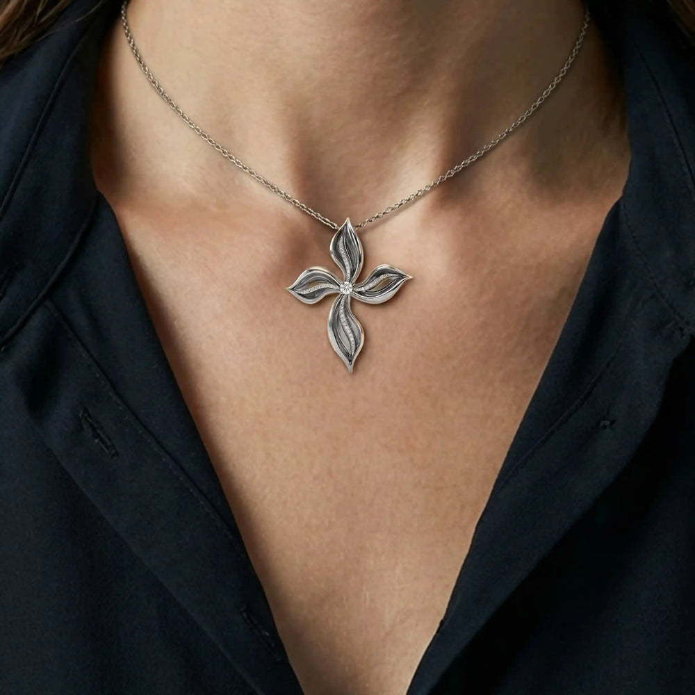 Floral cross lab-grown diamond pendant displayed upright on chest.