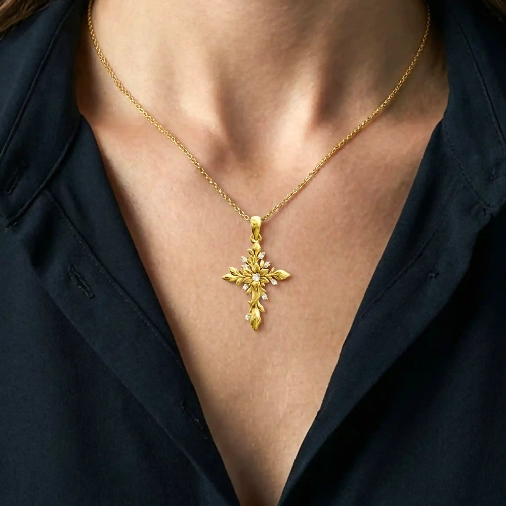 Floral cross lab-grown diamond pendant displayed on chest.