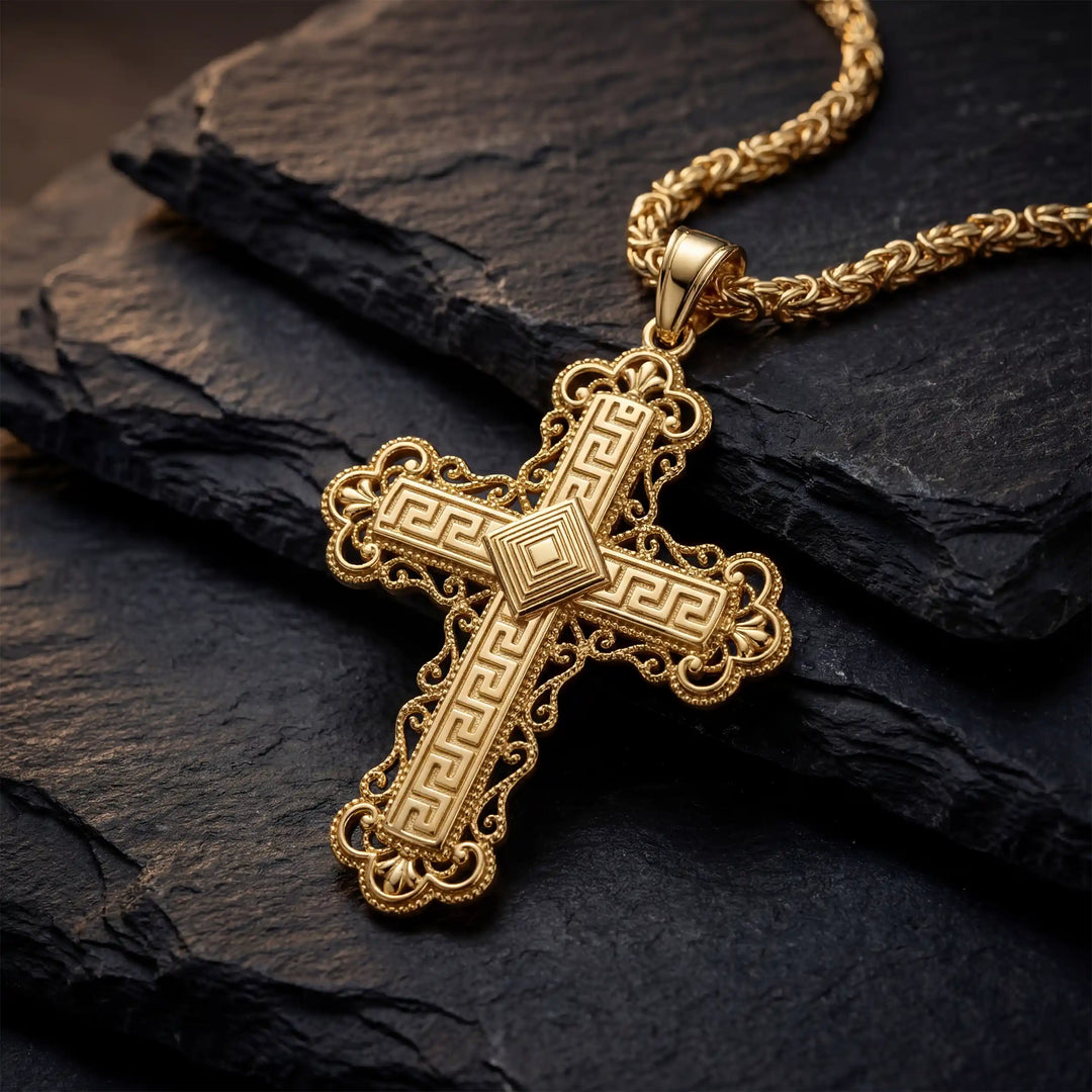 Ornate Greek cross pendant necklace with intricate decorative patterns displayed on black stone.