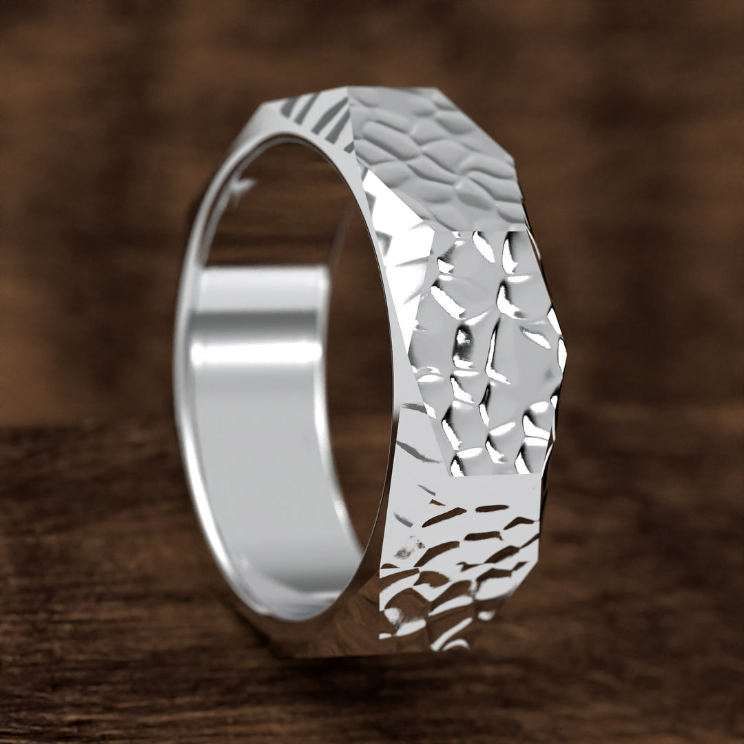 hammered hexagonal men’s wedding band with faceted texture