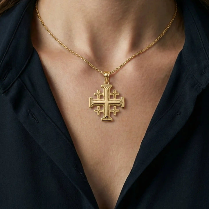 Jerusalem cross pendant necklace with central cross and four smaller crosses displayed on chest.