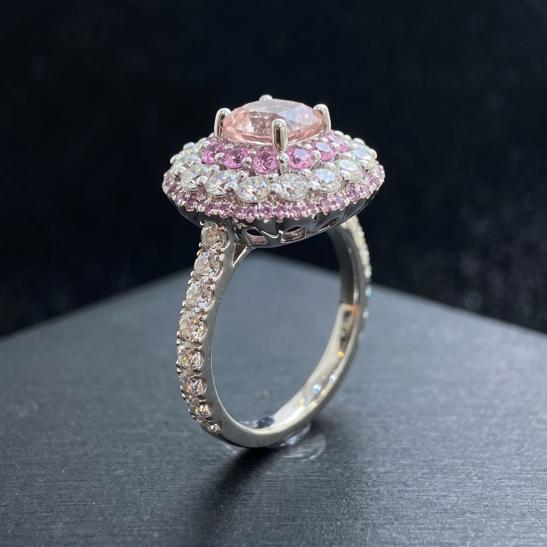 0.50 CT round lab diamond engagement ring with pink sapphire and moissanite halo on 14K gold.