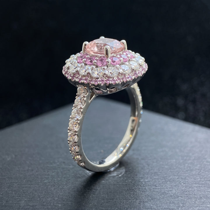 0.50 CT round lab diamond engagement ring with pink sapphire and moissanite halo on 14K gold.