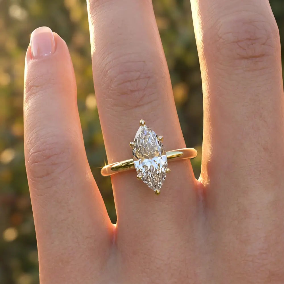 Marquise diamond six-prong solitaire engagement ring shown on a classic polished band.