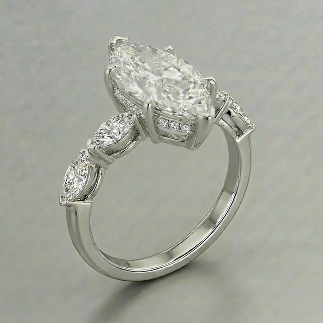2 carat marquise lab diamond engagement ring with hidden halo and marquise accent band on marbel.
