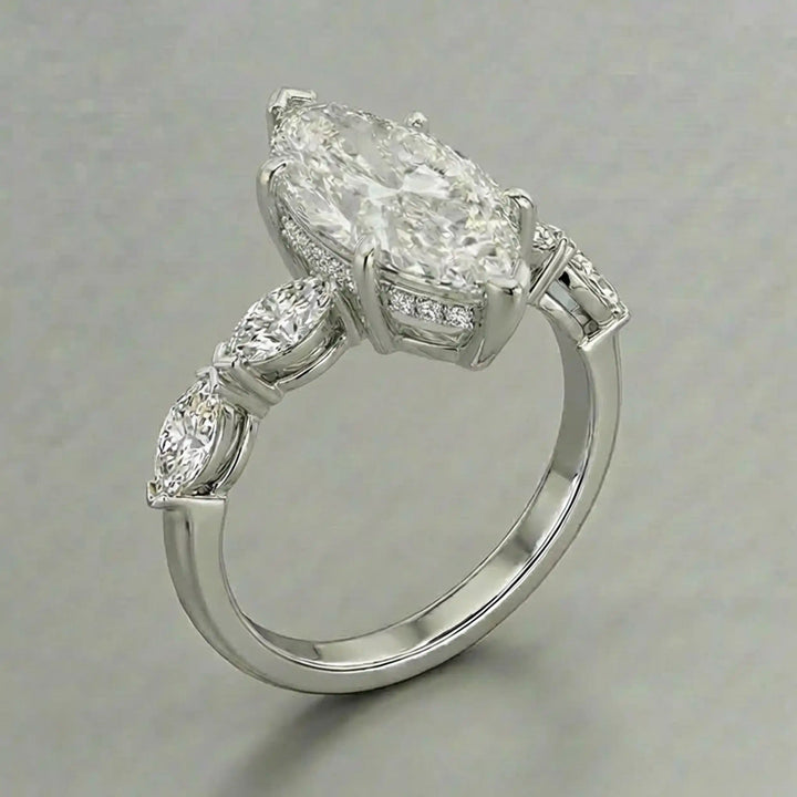 2 carat marquise lab diamond engagement ring with hidden halo and marquise accent band on marbel.
