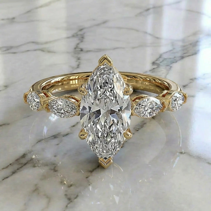 2 carat marquise lab diamond engagement ring with hidden halo and marquise accent band on marbel.
