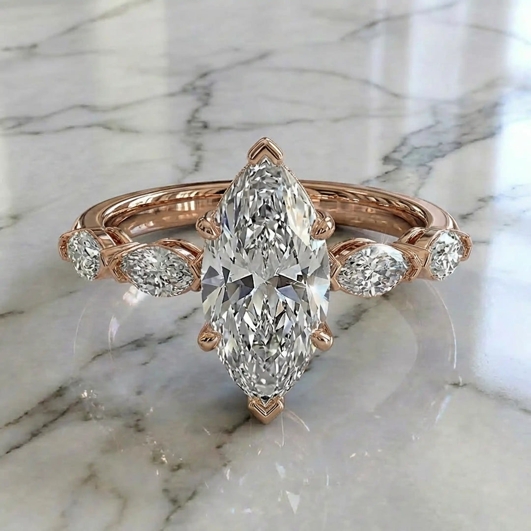 2 carat marquise lab diamond engagement ring with hidden halo and marquise accent band on marbel.
