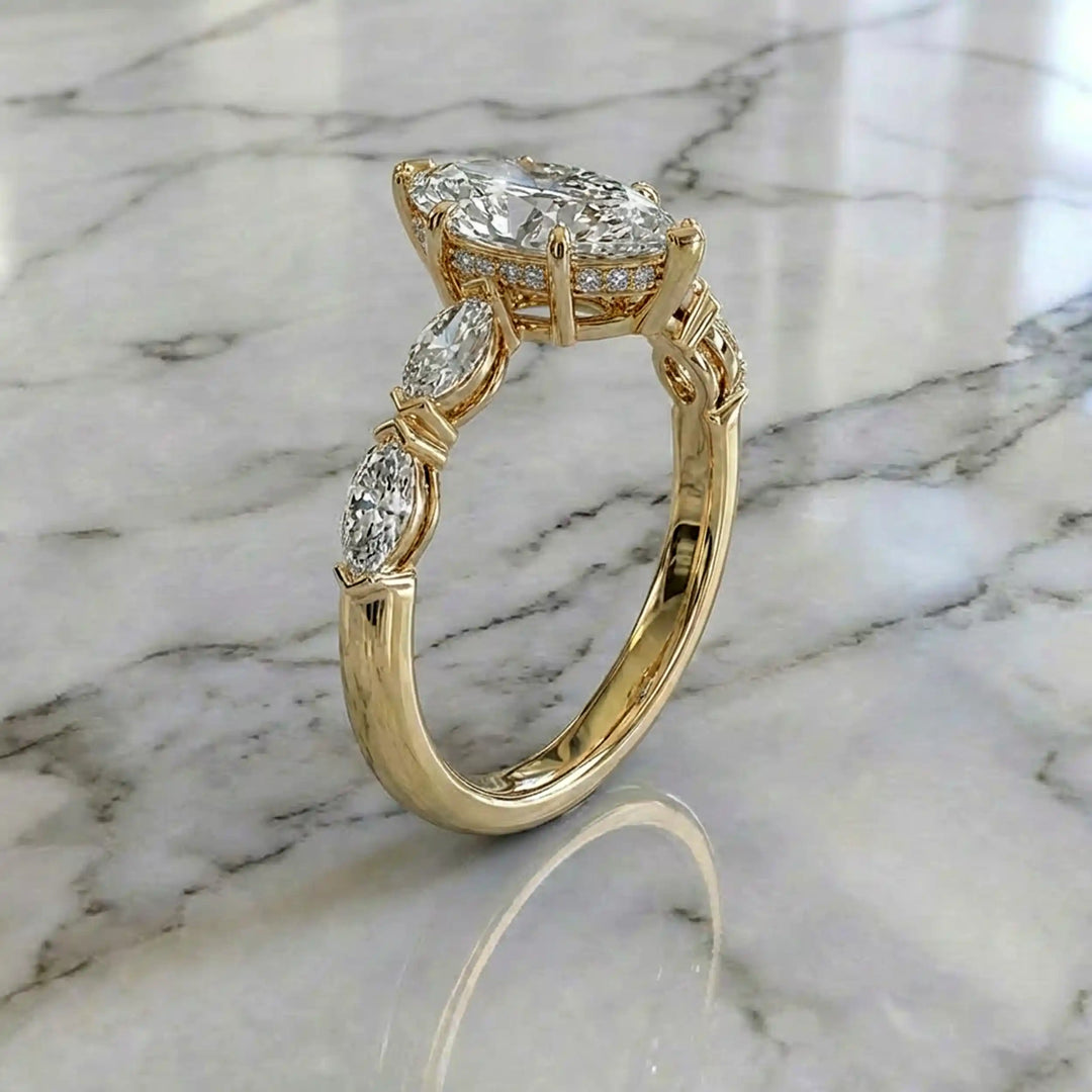 2 carat marquise lab diamond engagement ring with hidden halo and marquise accent band on marbel.
