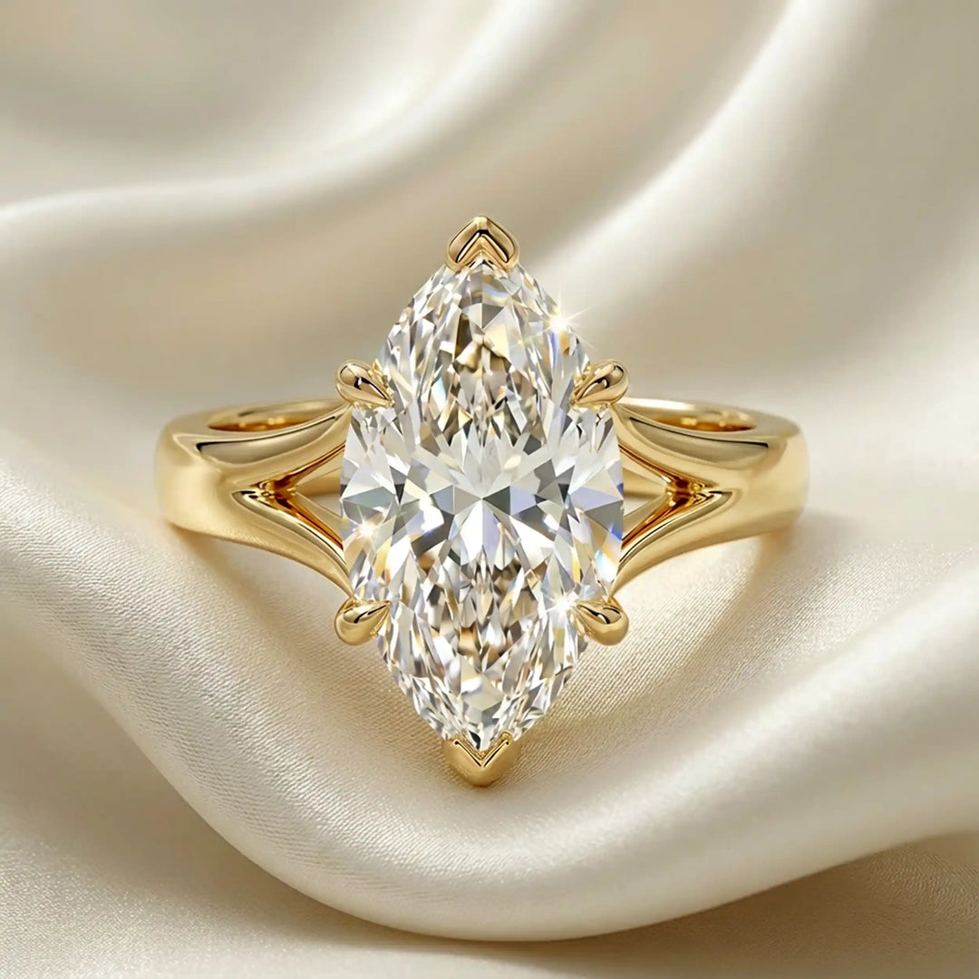 Marquise-cut lab-grown diamond split shank solitaire ring displayed on satin.
