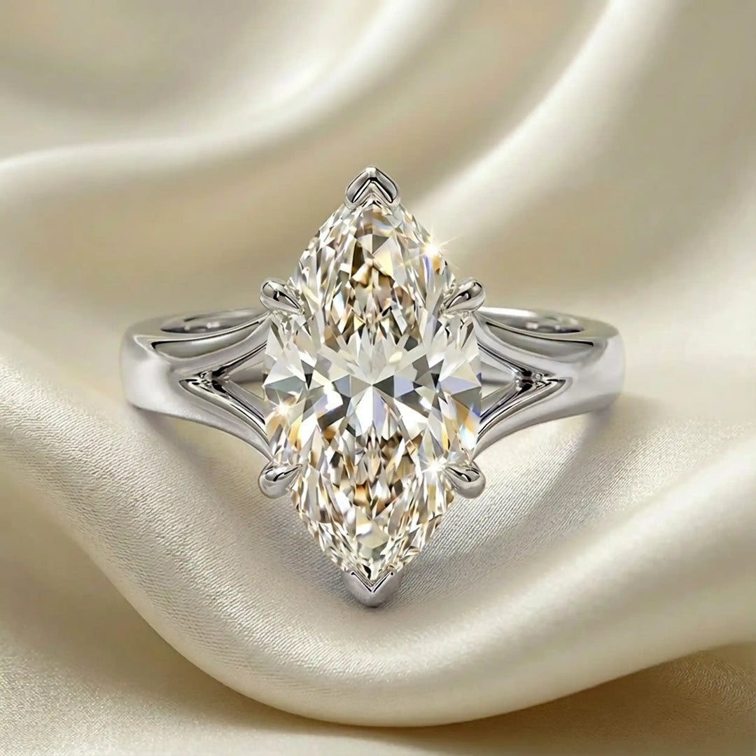 Marquise-cut lab-grown diamond split shank solitaire ring displayed on satin.
