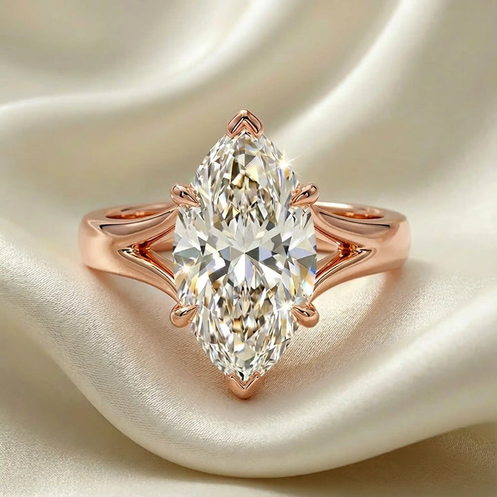 Marquise-cut lab-grown diamond split shank solitaire ring displayed on satin.
