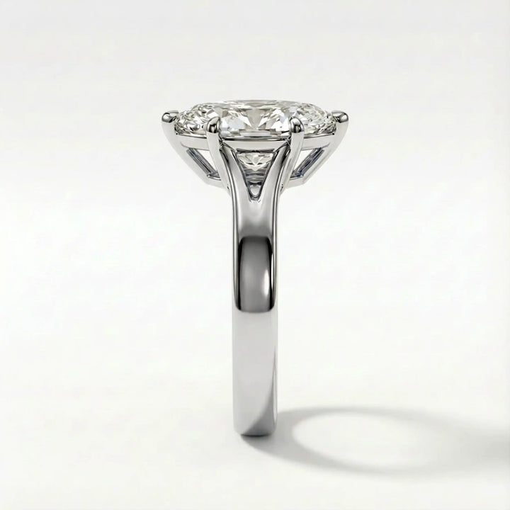 Marquise-cut lab-grown diamond split shank solitaire ring displayed on satin.
