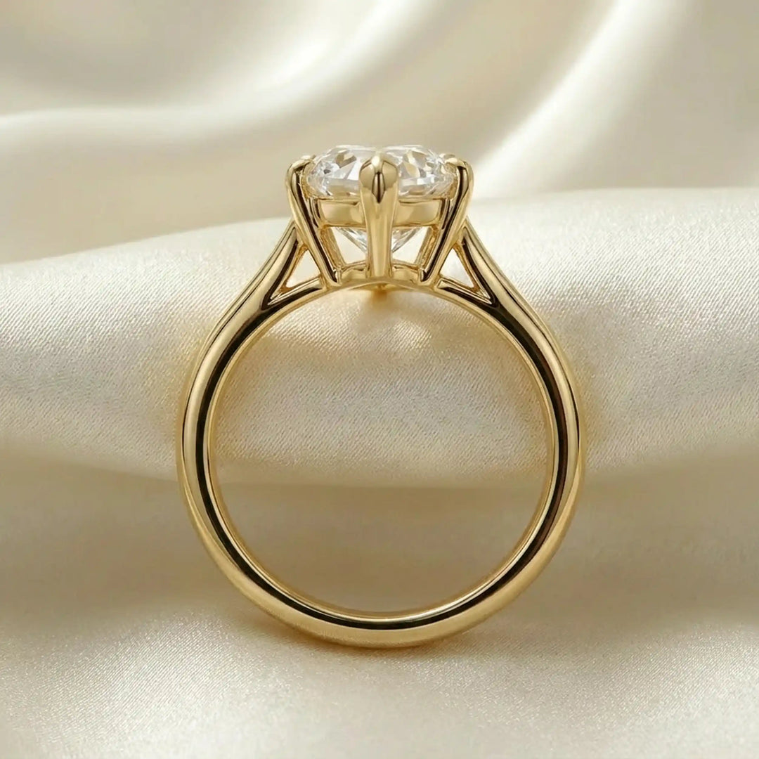 Marquise-cut lab-grown diamond split shank solitaire ring displayed on satin.
