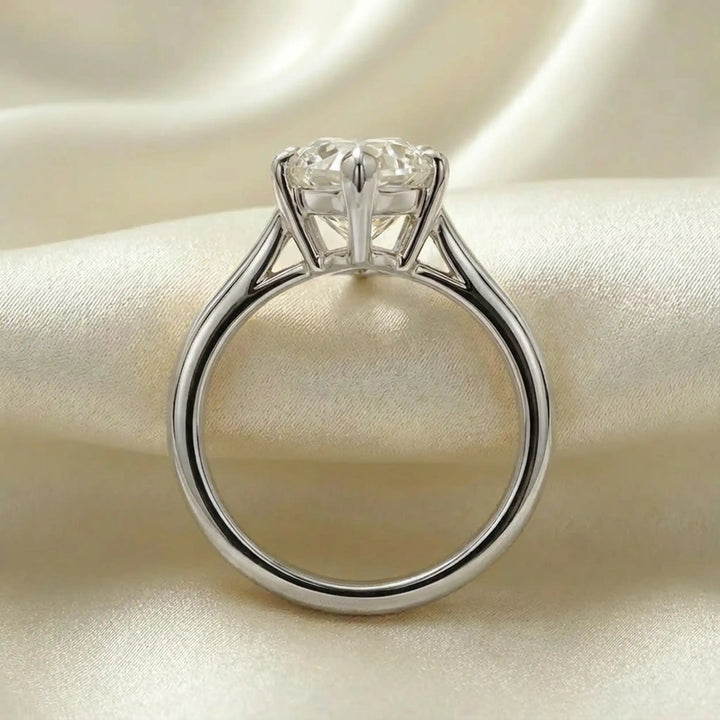 Marquise-cut lab-grown diamond split shank solitaire ring displayed on satin.
