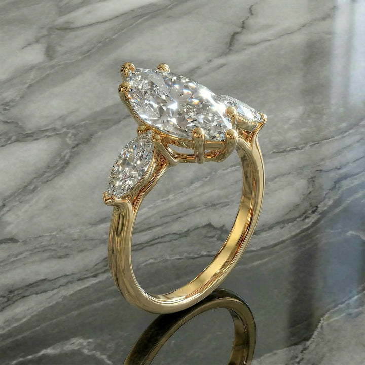 Marquise three-stone lab-grown diamond engagement ring shown on reflective surface.
