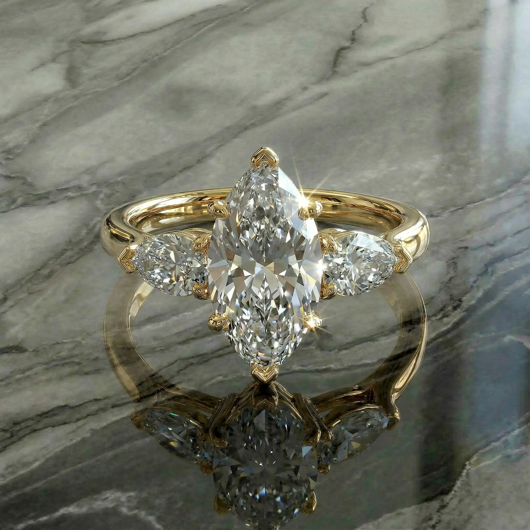 Marquise three-stone lab-grown diamond engagement ring shown on reflective surface.
