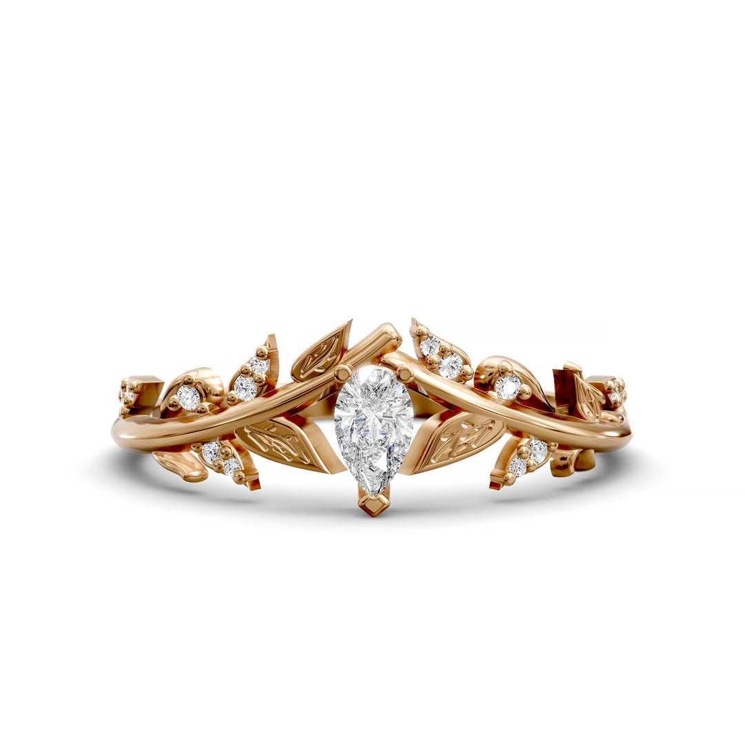 Leaf and vine wedding band with pear-shaped center stone and small accent stones