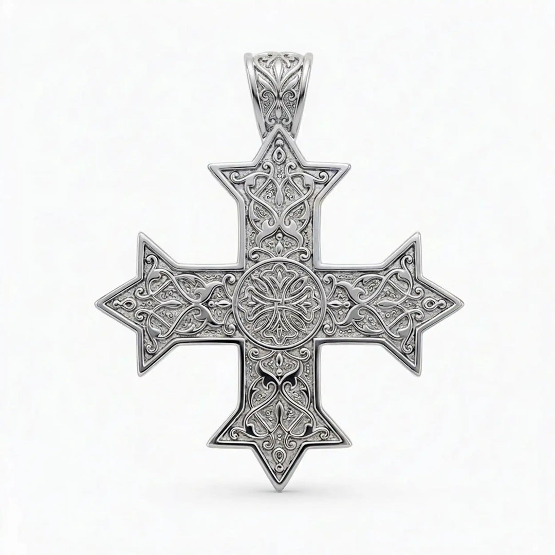 Ornate Coptic cross pendant with intricate filigree pattern displayed on neutral background.
