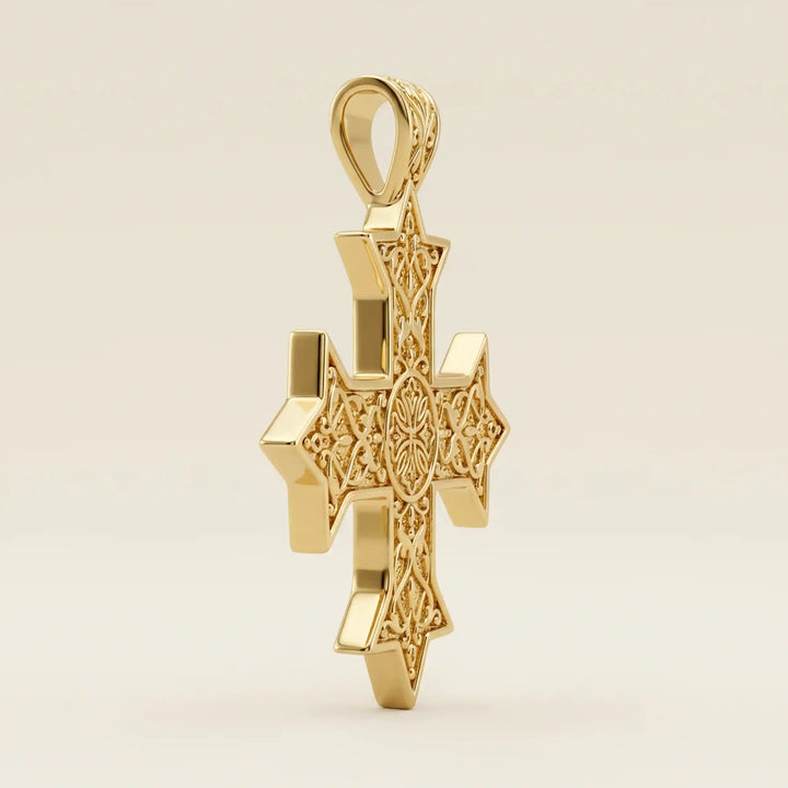 Ornate Coptic cross pendant with intricate filigree pattern displayed on neutral background.
