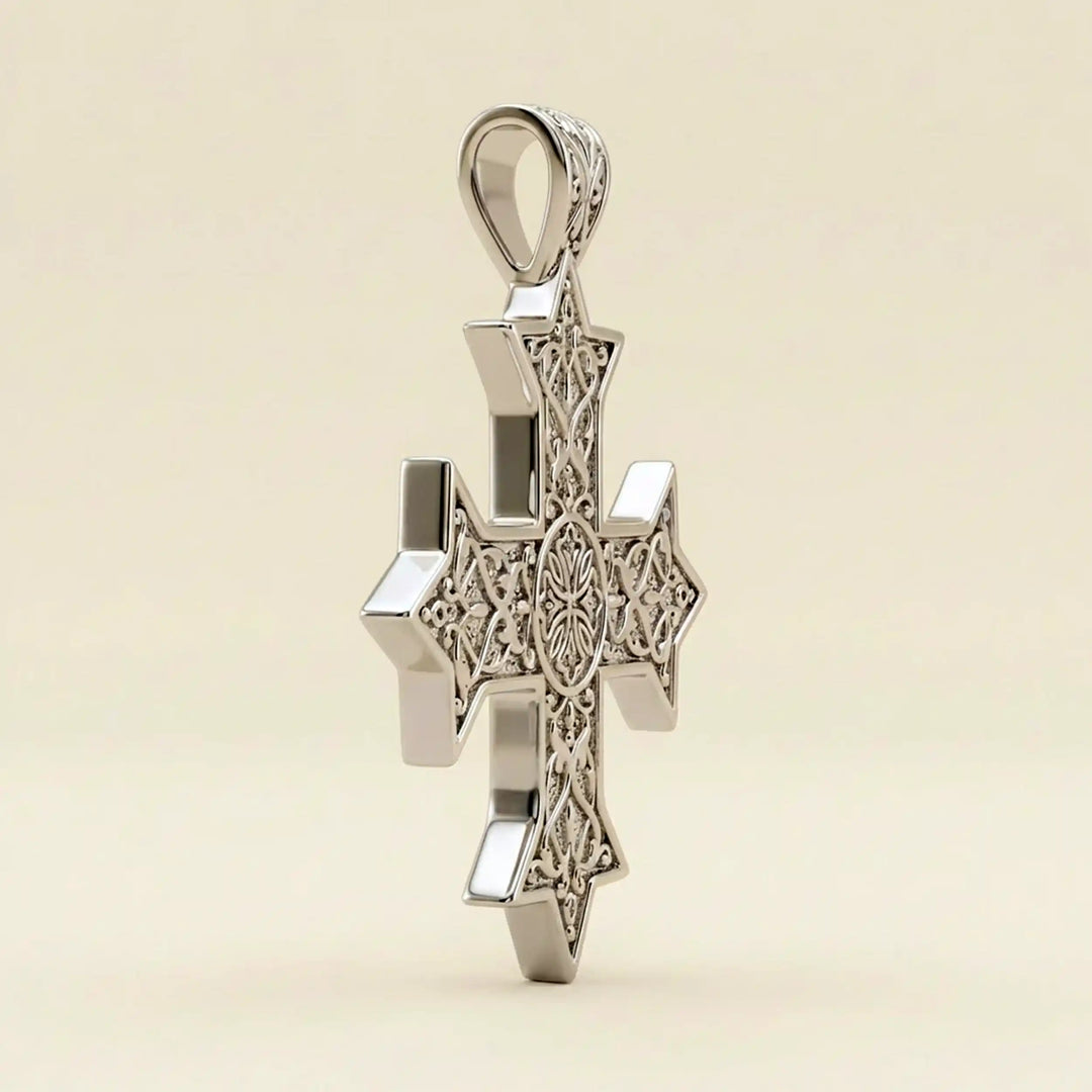 Ornate Coptic cross pendant with intricate filigree pattern displayed on neutral background.
