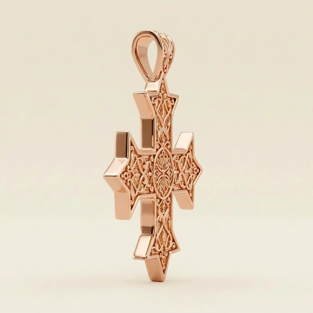Ornate Coptic cross pendant with intricate filigree pattern displayed on neutral background.
