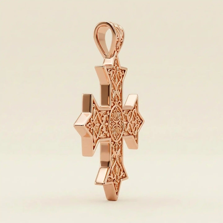 Ornate Coptic cross pendant with intricate filigree pattern displayed on neutral background.
