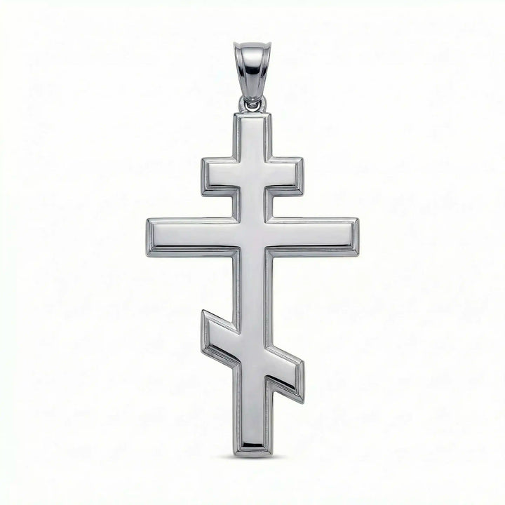 Orthodox three-bar Christian cross pendant displayed on white background.