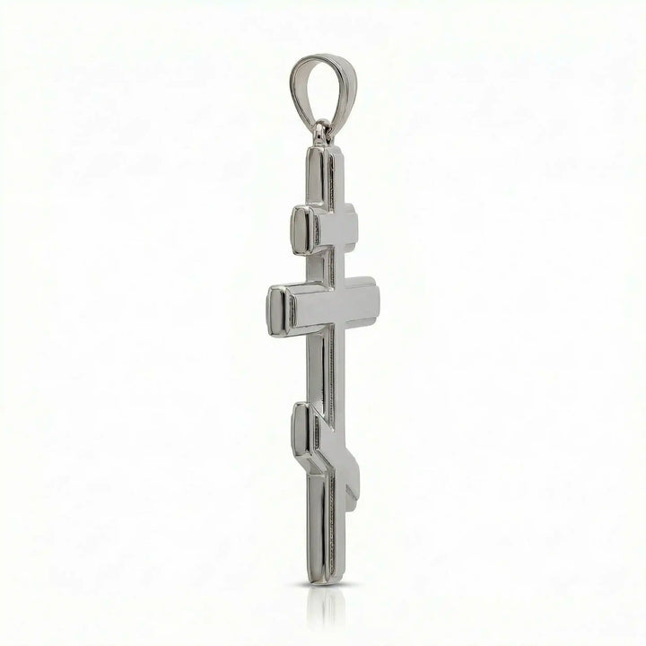 Orthodox three-bar Christian cross pendant displayed on white background.