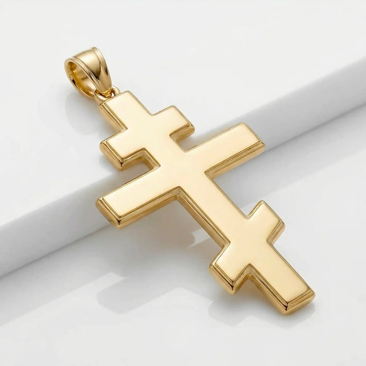 Orthodox three-bar Christian cross pendant displayed on white background.