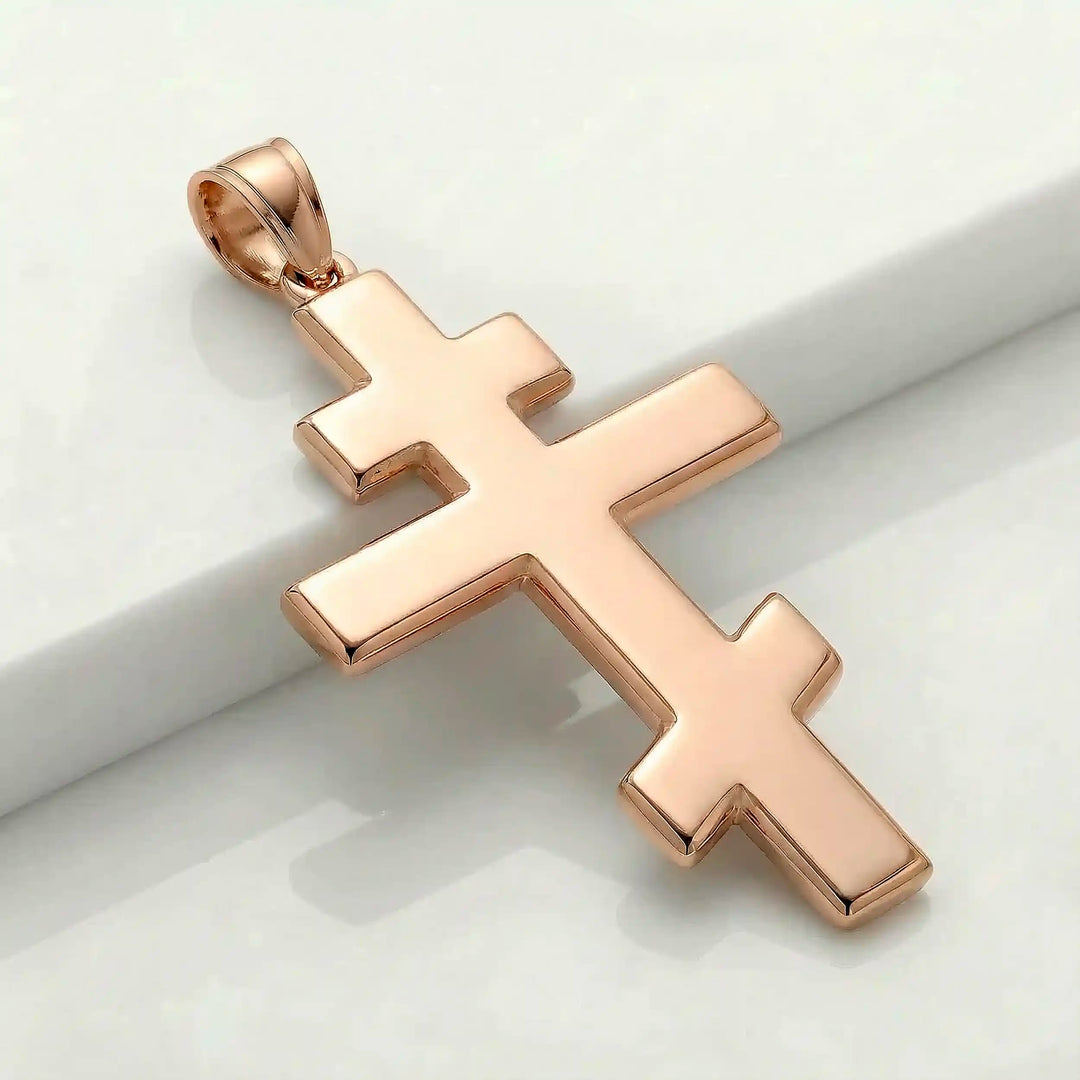 Orthodox three-bar Christian cross pendant displayed on white background.