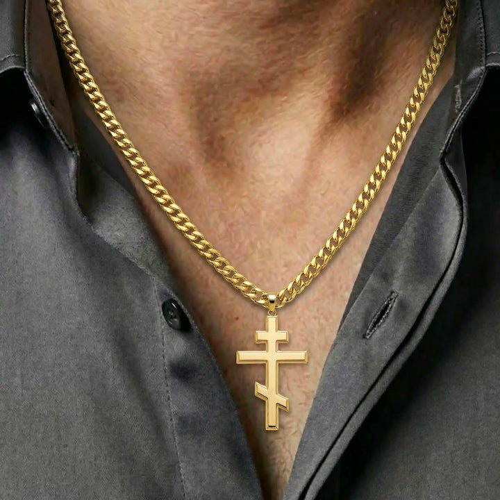 Orthodox three-bar Christian cross pendant displayed on chest.