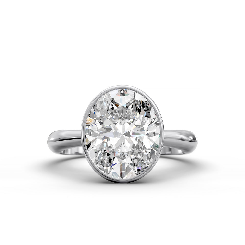 Oval bezel vintage diamond engagement ring with polished band in studio view.