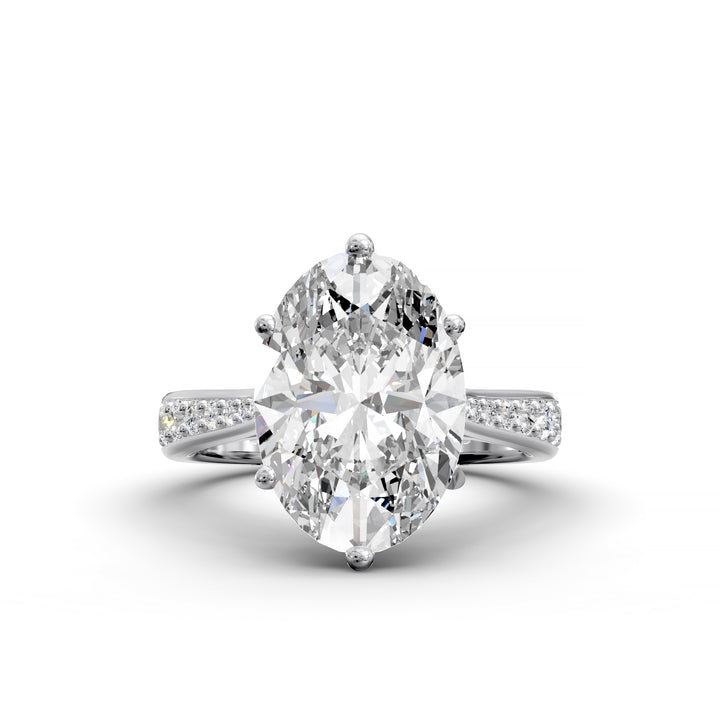 Oval diamond cathedral engagement ring with channel-set band shown in studio view.