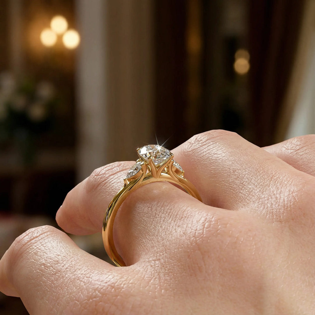 Oval diamond engagement ring with pear-shaped side stones front view.