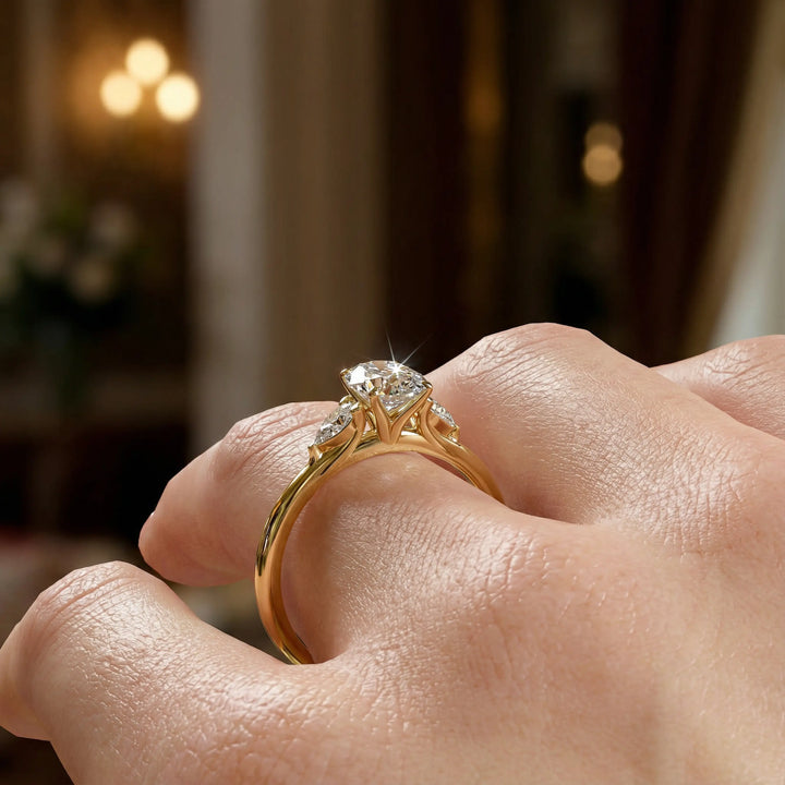 Oval diamond engagement ring with pear-shaped side stones front view.