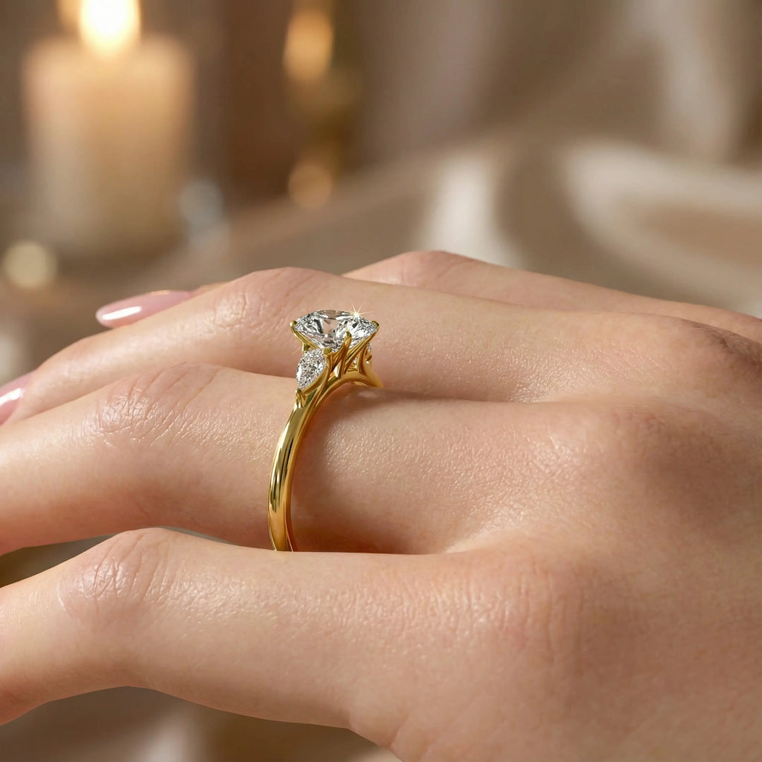 Oval diamond engagement ring with pear-shaped side stones front view.