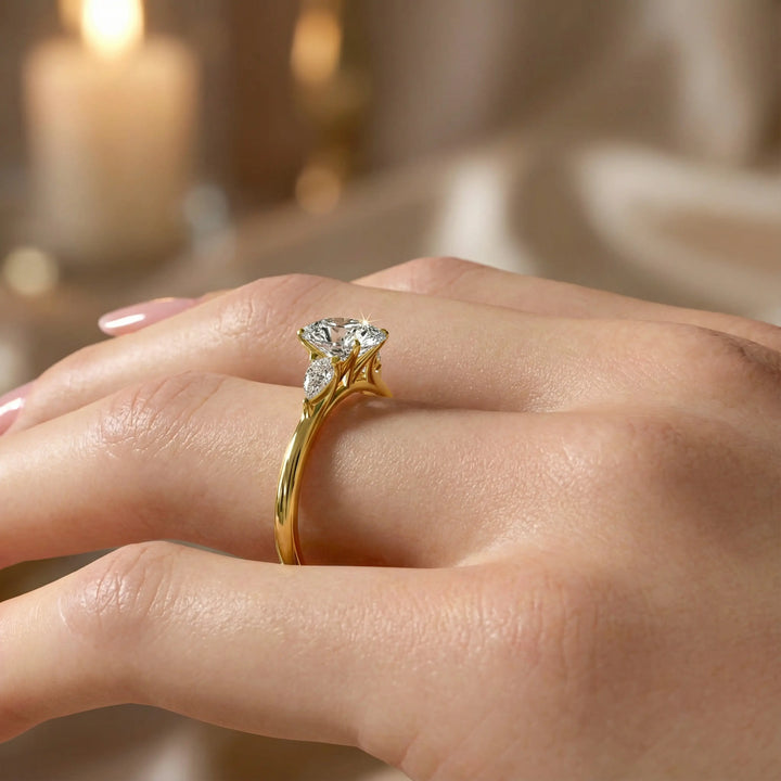 Oval diamond engagement ring with pear-shaped side stones front view.