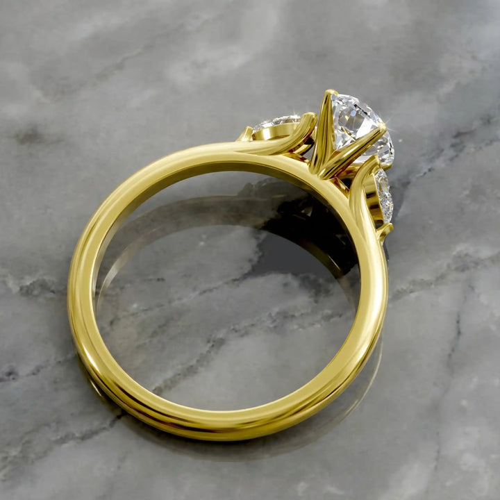 Oval diamond engagement ring with pear-shaped side stones front view.