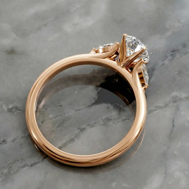Oval diamond engagement ring with pear-shaped side stones front view.