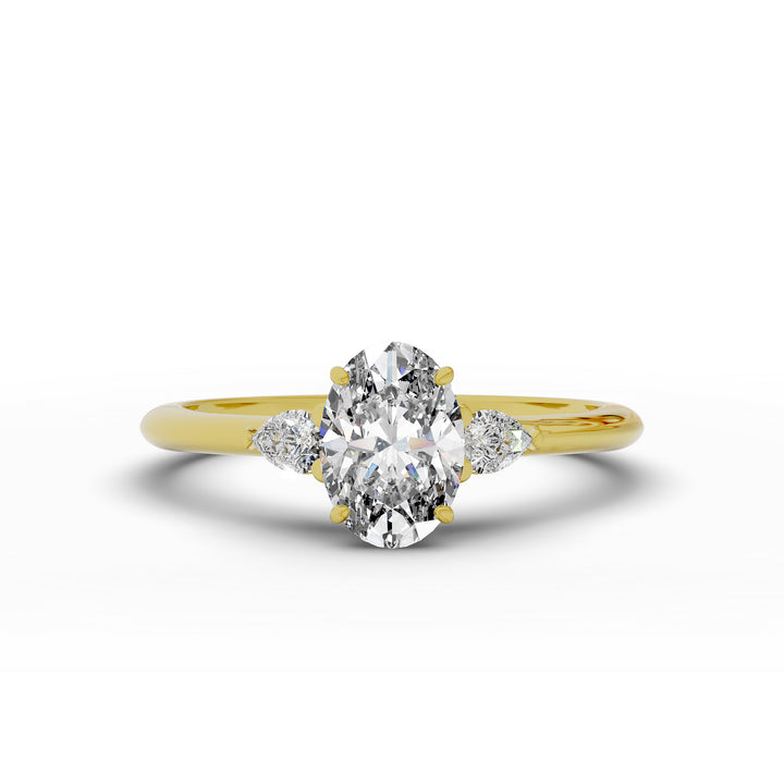 Oval diamond engagement ring with pear-shaped side stones front view.