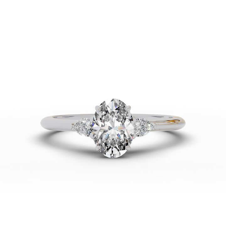 Oval diamond engagement ring with pear-shaped side stones front view.