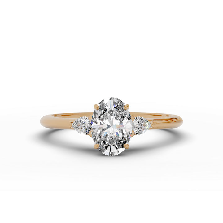 Oval diamond engagement ring with pear-shaped side stones front view.