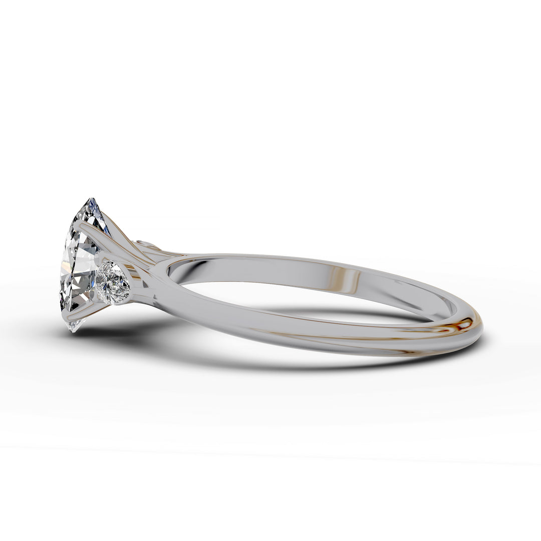 Oval diamond engagement ring with pear-shaped side stones front view.